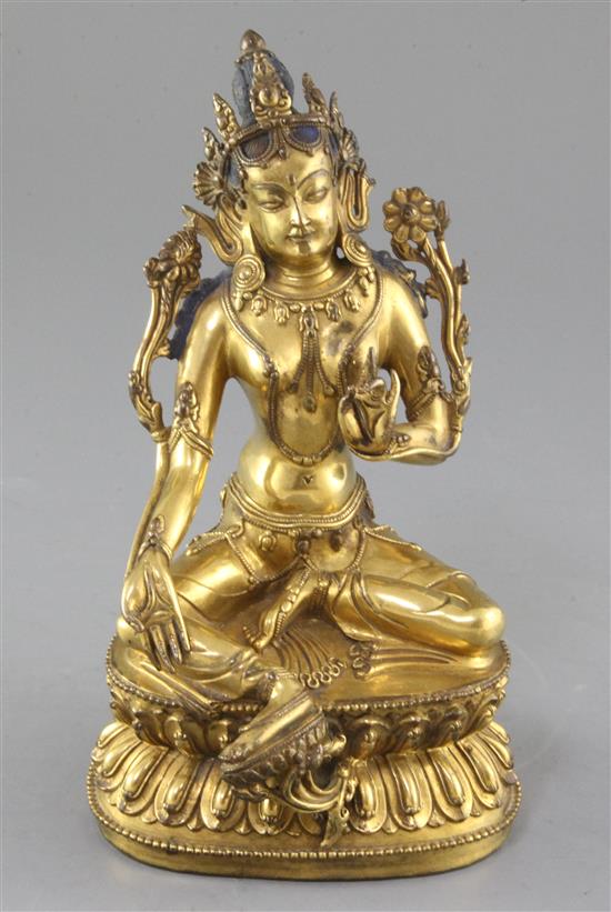 A gilt Tibetan gilt bronze seated figure of Green Tara, 18th century, height 21.5cm